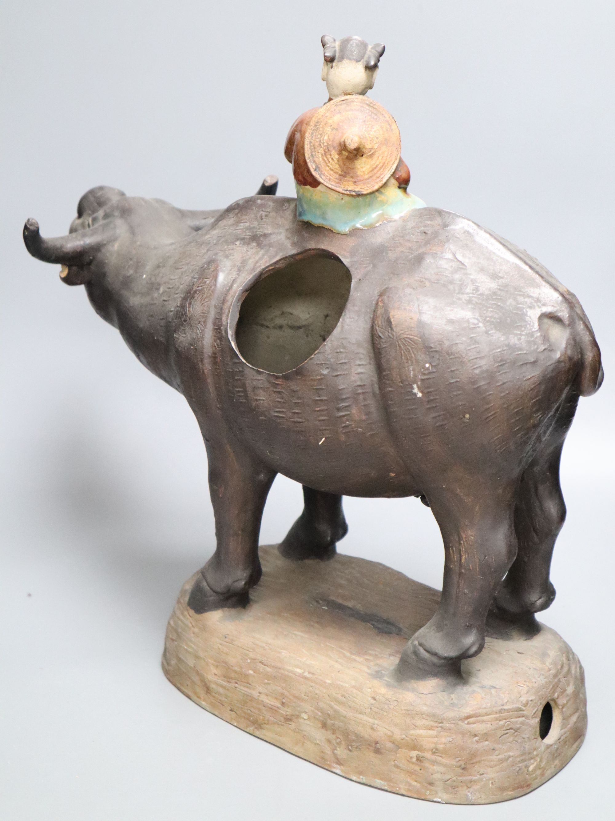 A large Chinese pottery group of a man riding an ox, Guandong kilns, height 40cm